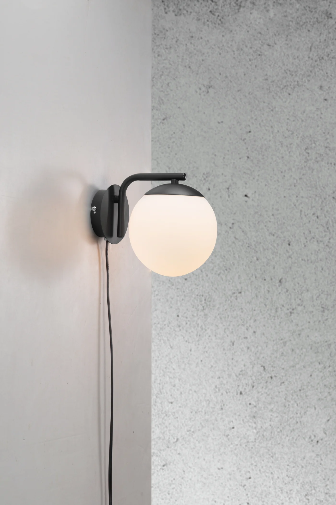 
                  
                    Lara - Wall light Black E14 Glamorous modern style in matte white opal mouth blown glass and Black Metal plate provides a cosy atmosphere in the room
                  
                